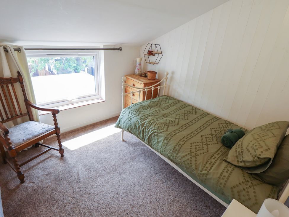 A bedroom with a bed and window at 3 Rectory Row