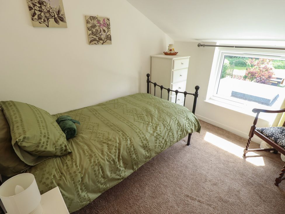 A bedroom with a bed and window at 3 Rectory Row