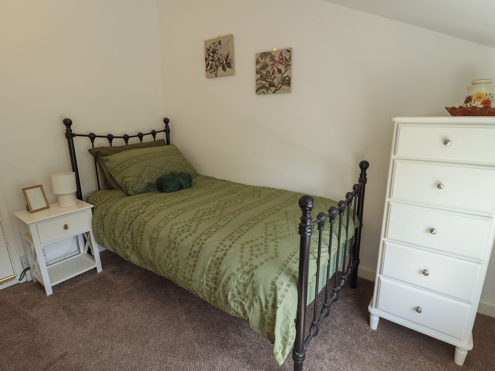 A bedroom with a bed and a nightstand at 3 Rectory Row