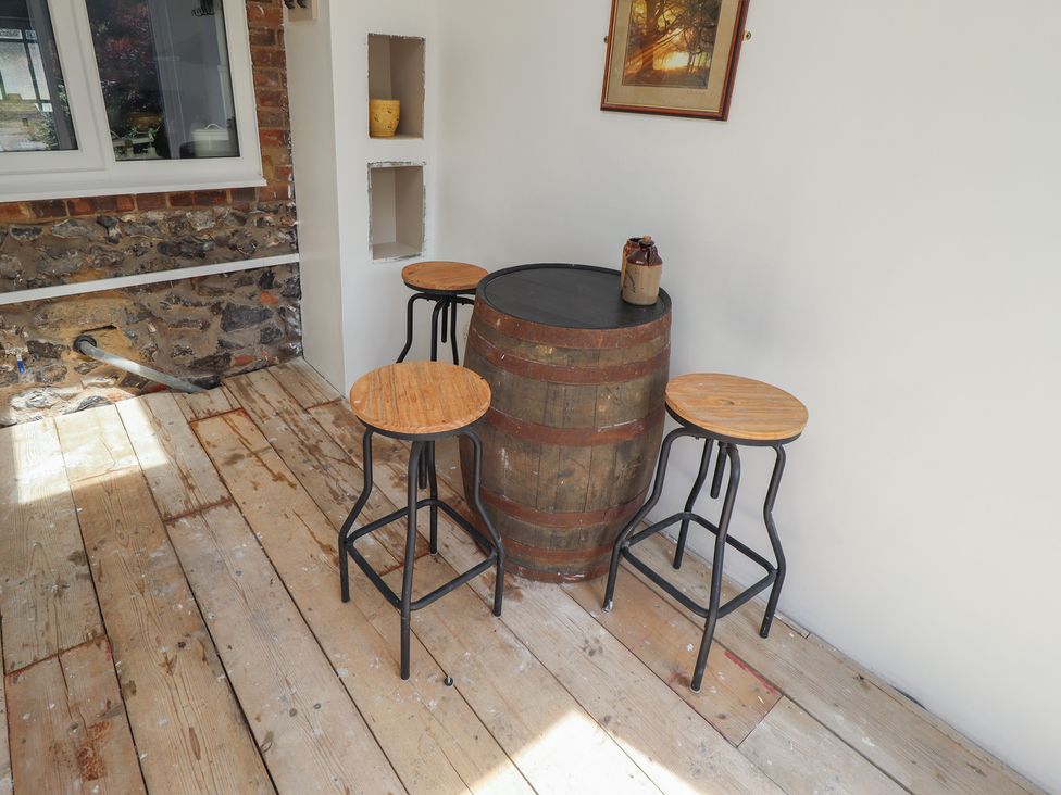 A snug area with a barrel table and stools at 3 Rectory Row
