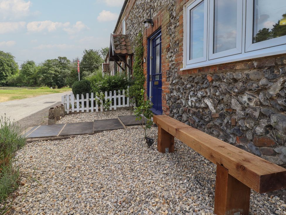 An outdoor area with a bench and pebbled path at 3 Rectory Row 