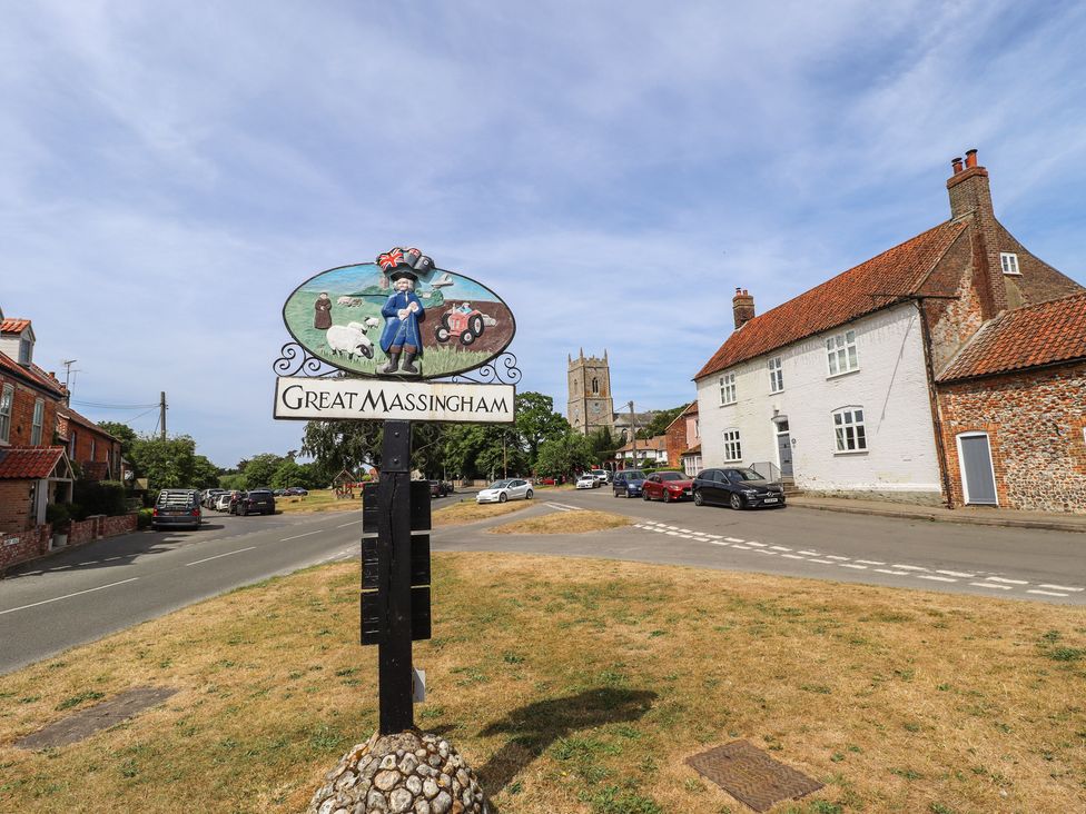 A street view with a sign for Great Massingham and buildings at 3 Rectory Row