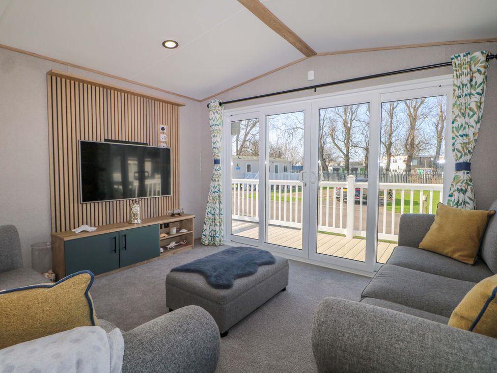 A living room with a television and seating area at 0028 South Beach