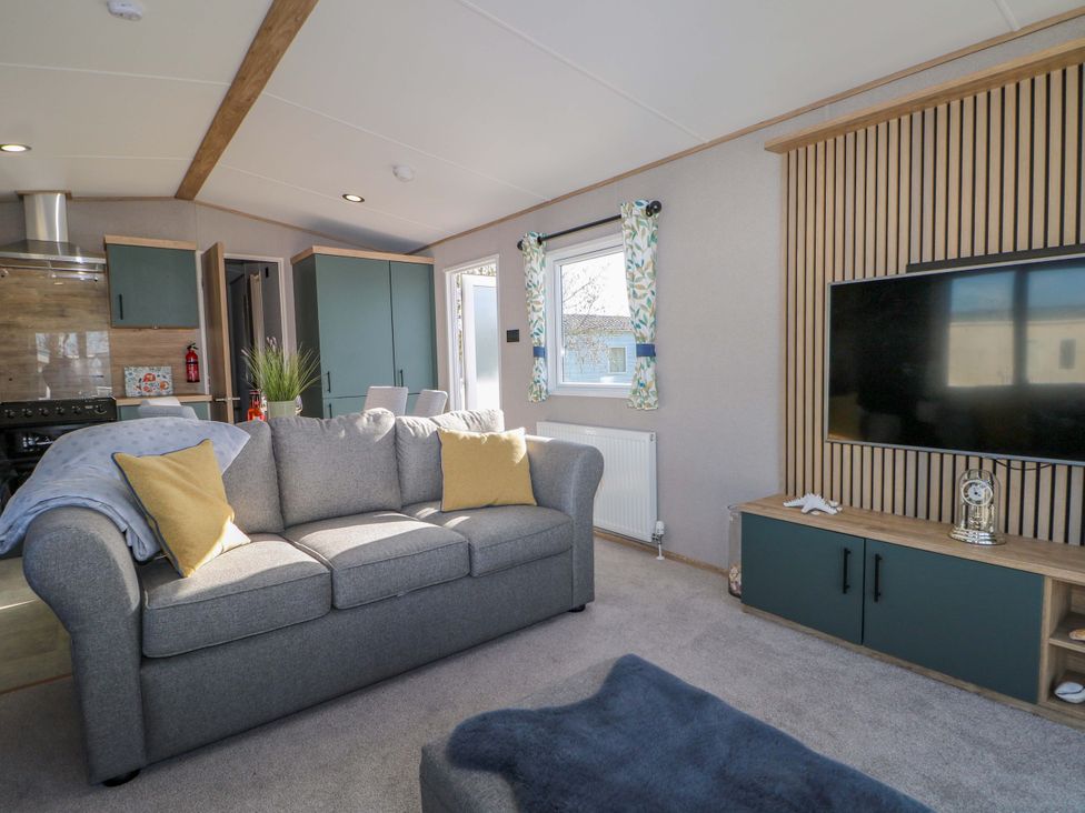 A living room with a sofa and television at 0028 South Beach