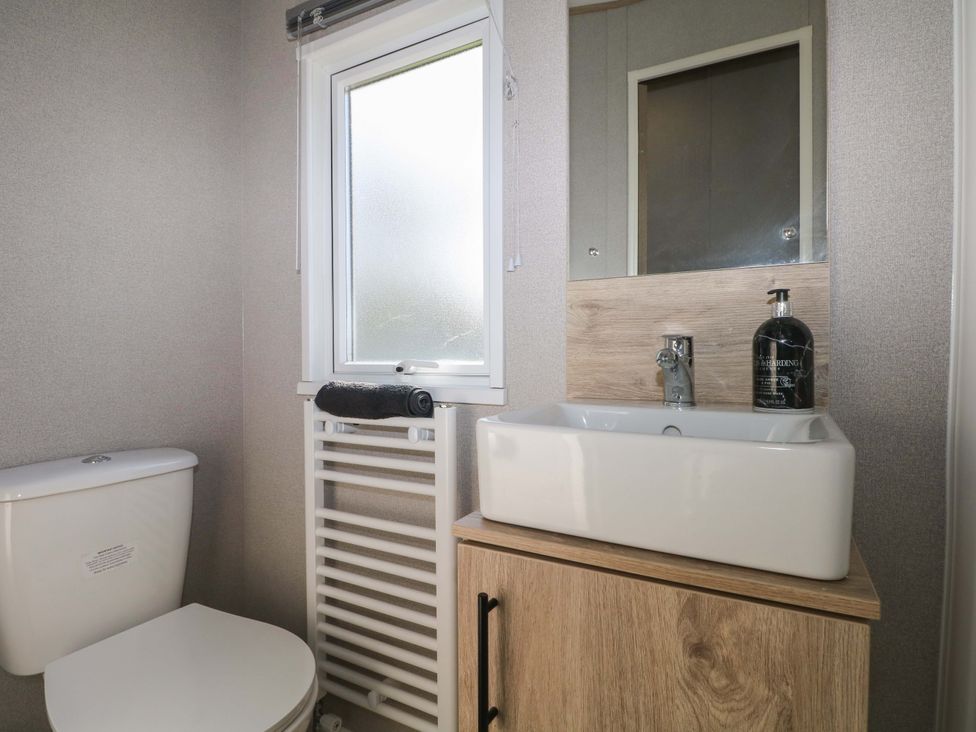 A bathroom with a toilet and sink at 0028 South Beach