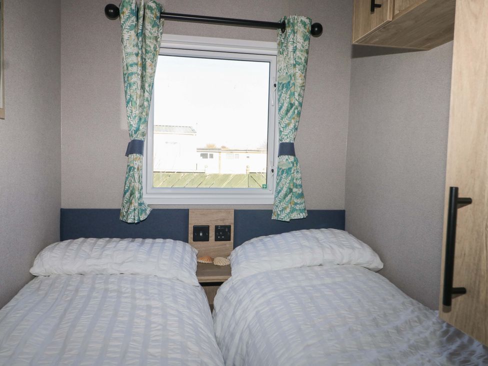 A bedroom with two beds and a window at 0028 South Beach