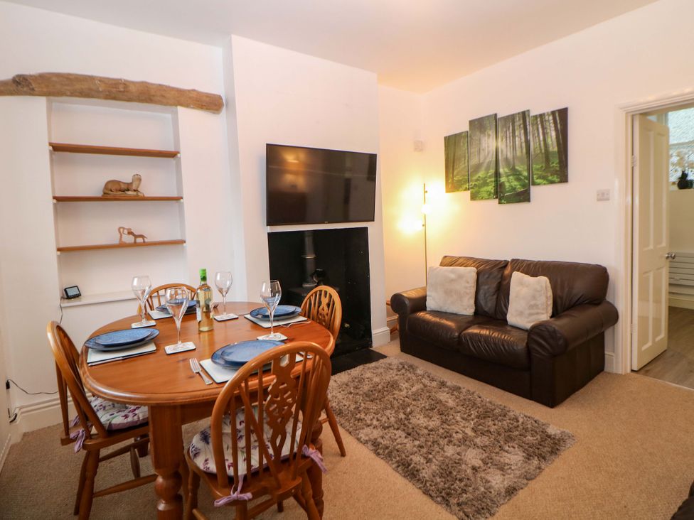 A living room with a dining table and sofa at Nature's Retreat in Matlock