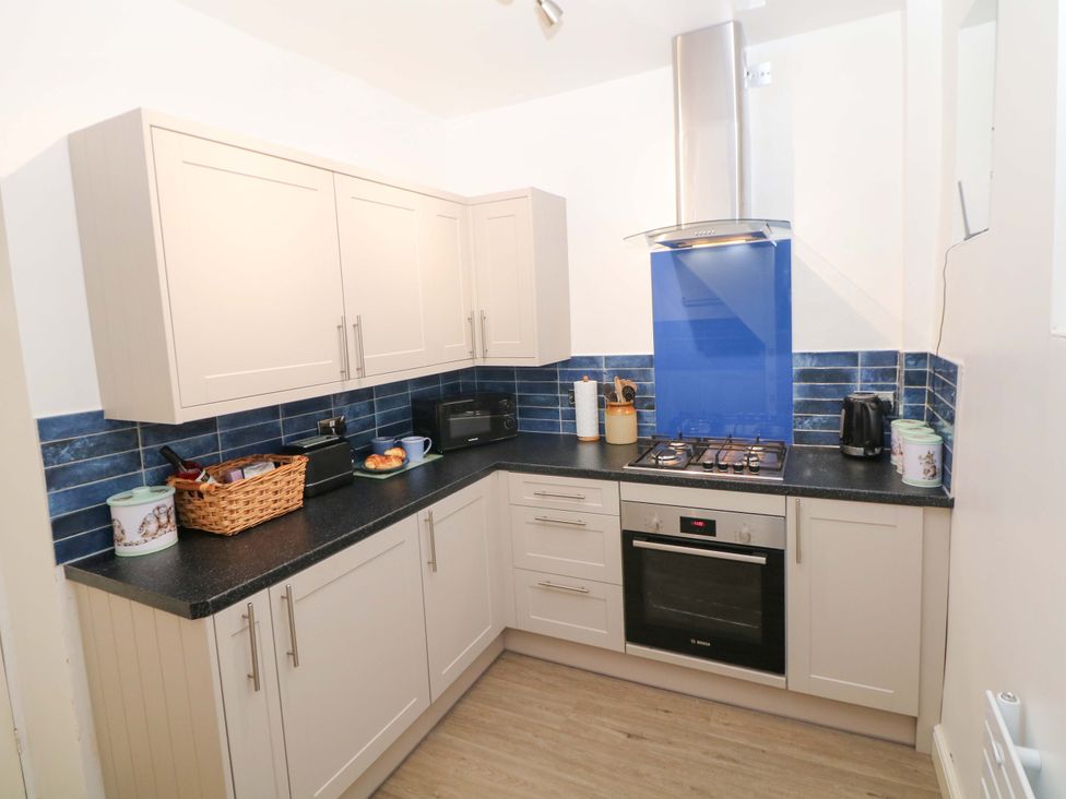 A kitchen with cabinets and appliances at Nature’s Retreat in Matlock