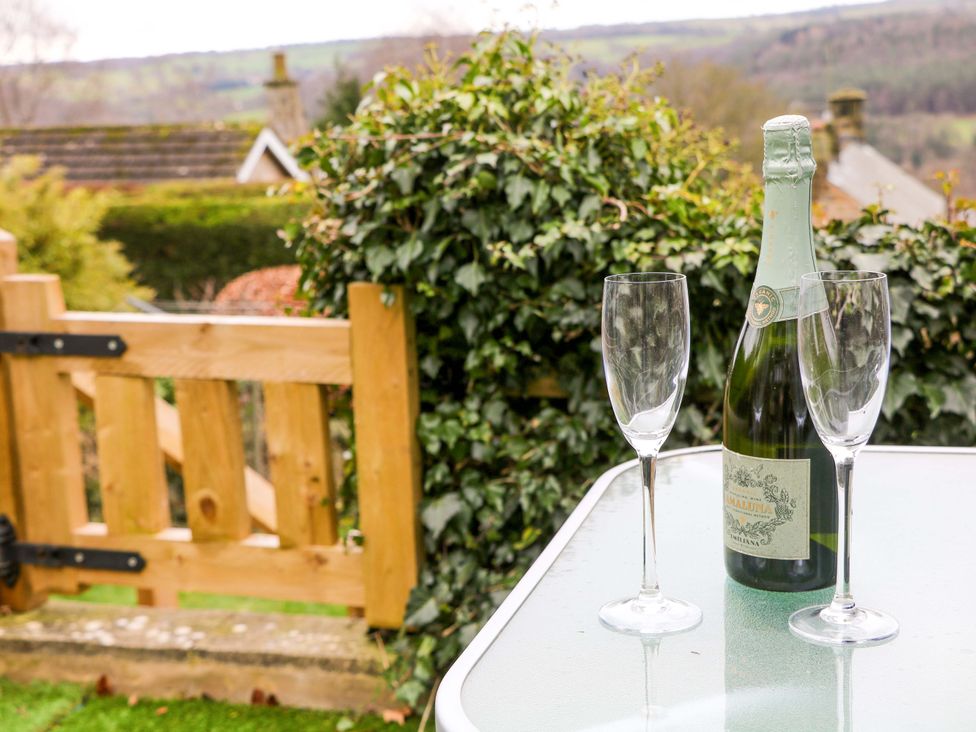 A bottle of champagne and two glasses on a table at Nature’s Retreat in Matlock