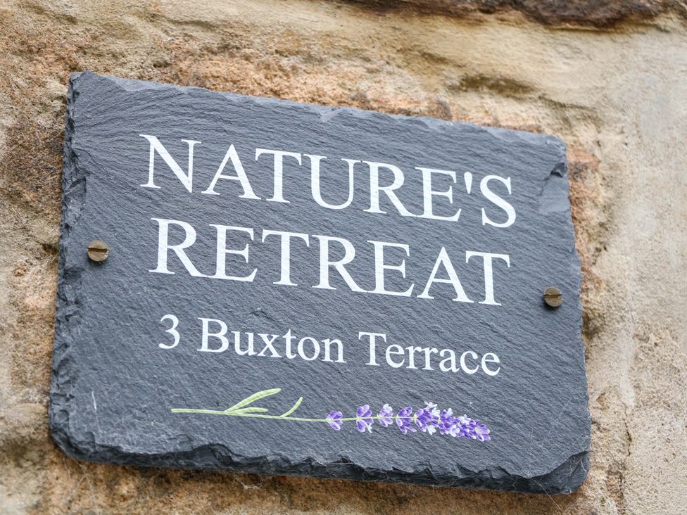 A nameplate for Nature's Retreat at 3 Buxton Terrace in Matlock