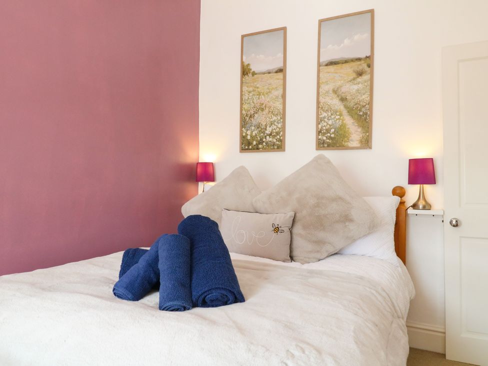 A bedroom with a bed and towels arranged at Nature’s Retreat in Holloway