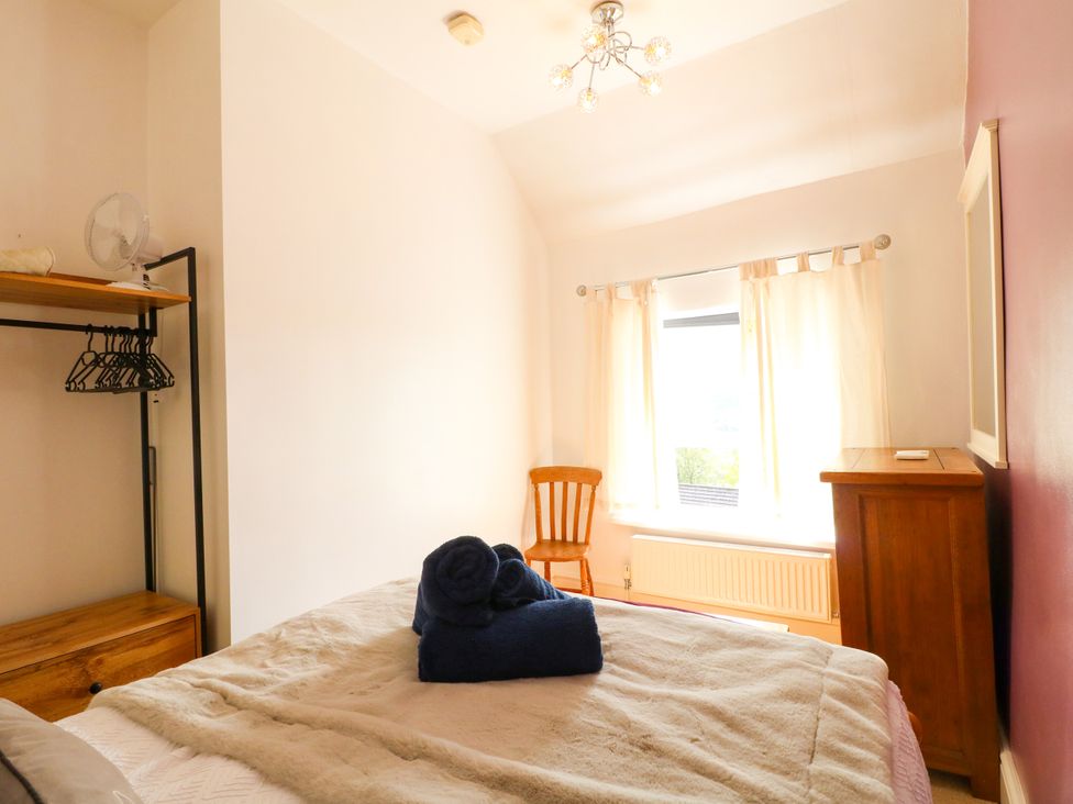 A bedroom with a bed and a chair at Nature’s Retreat in Holloway
