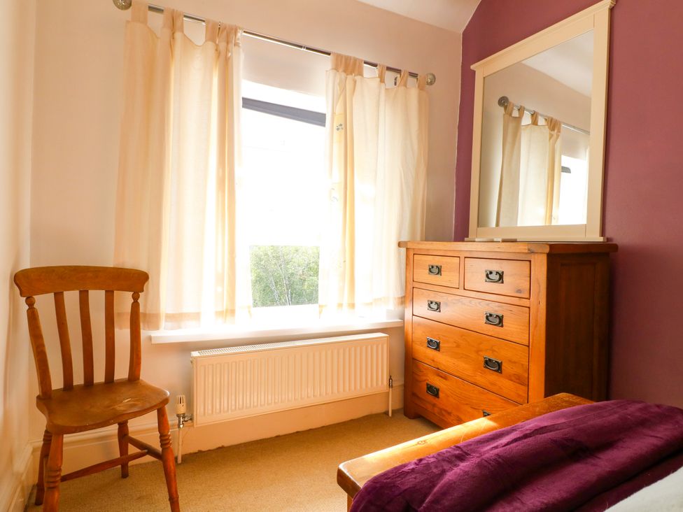 A bedroom with a chair and a dresser at Nature’s Retreat in Holloway