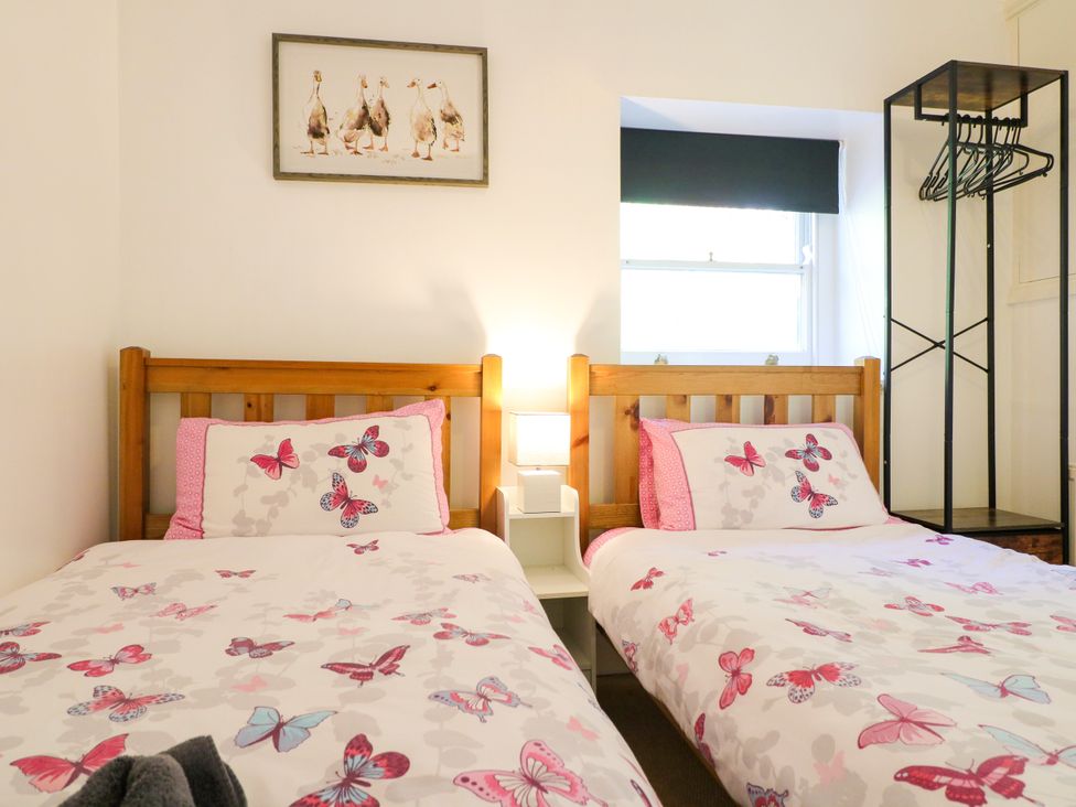 A bedroom with two beds and a nightstand at Nature’s Retreat in Holloway