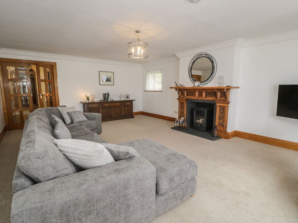 A living room featuring a sofa and a fireplace at The Boat Yard Apartment in Porthmadog