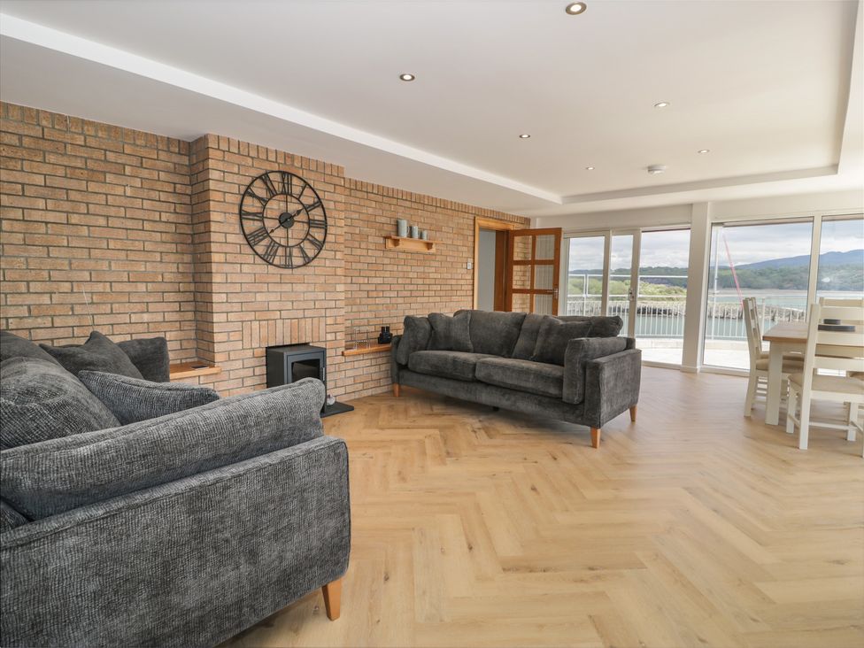 A living room with a sofa and fireplace at The Boat Yard Apartment Porthmadog