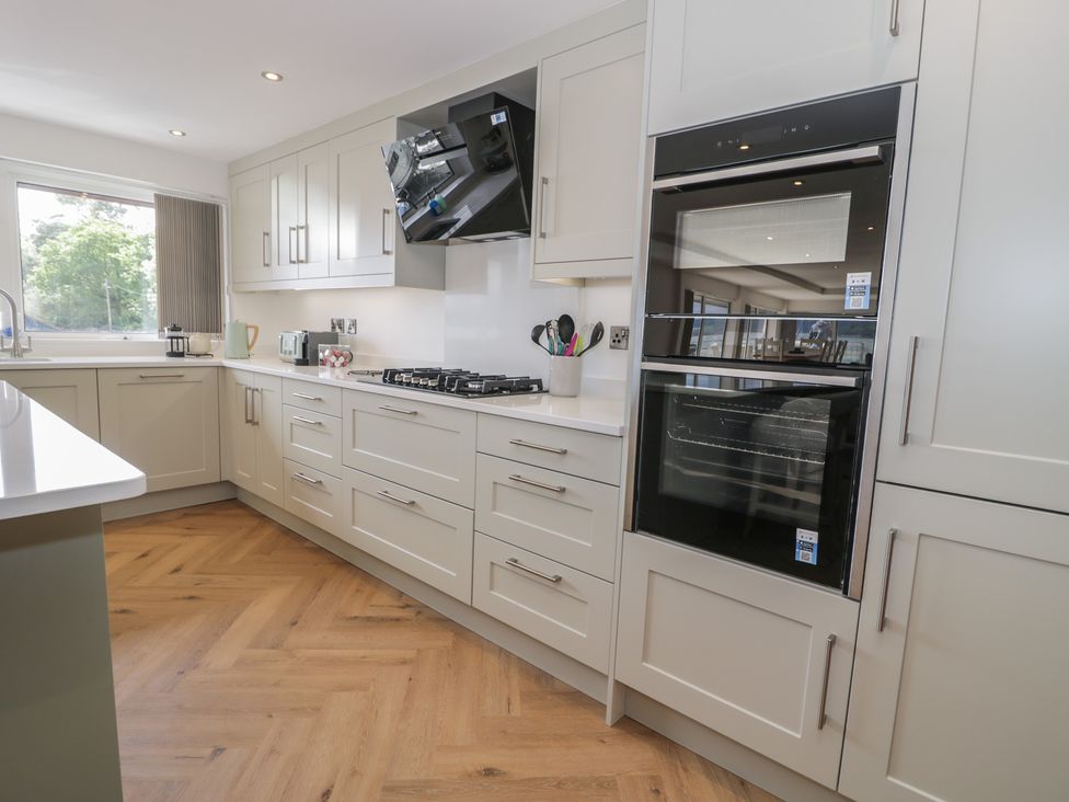 A kitchen with a stovetop and oven at The Boat Yard Apartment in Porthmadog