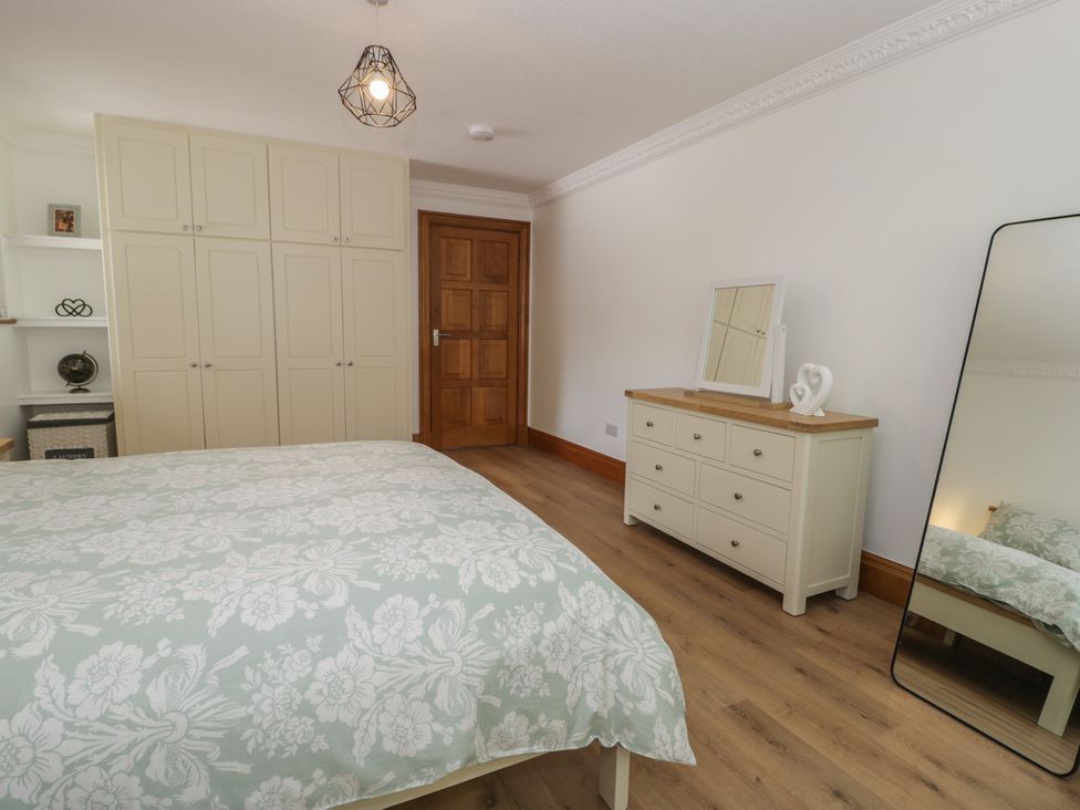 A bedroom with a bed and furniture at The Boat Yard Apartment Porthmadog