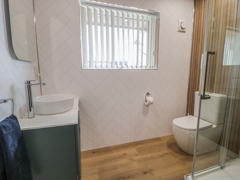 A bathroom with a sink and a toilet at The Boat Yard Apartment Porthmadog