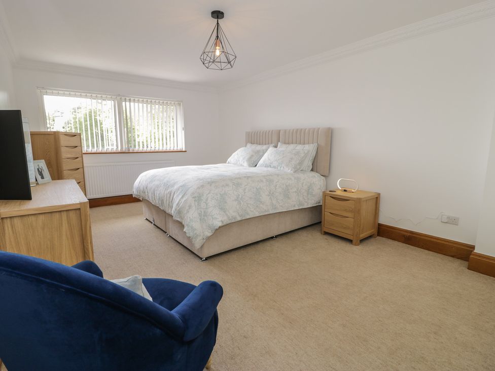 A bedroom with bed and dresser at The Boat Yard Apartment Porthmadog