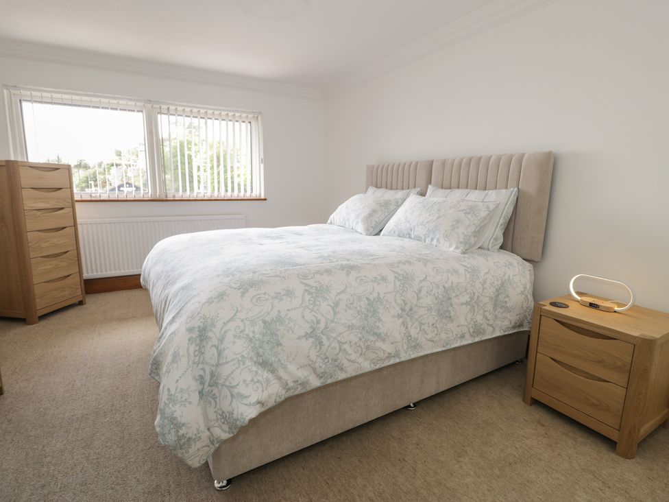 A bedroom with a bed and a chest of drawers at The Boat Yard Apartment in Porthmadog