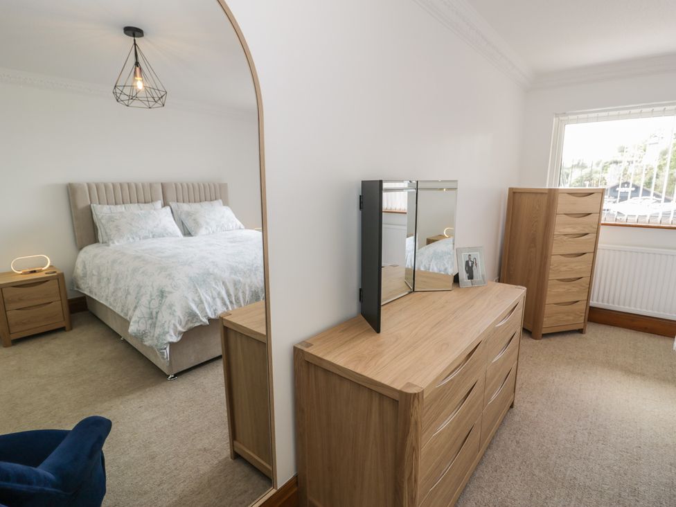 A bedroom with a bed and furniture at The Boat Yard Apartment in Porthmadog