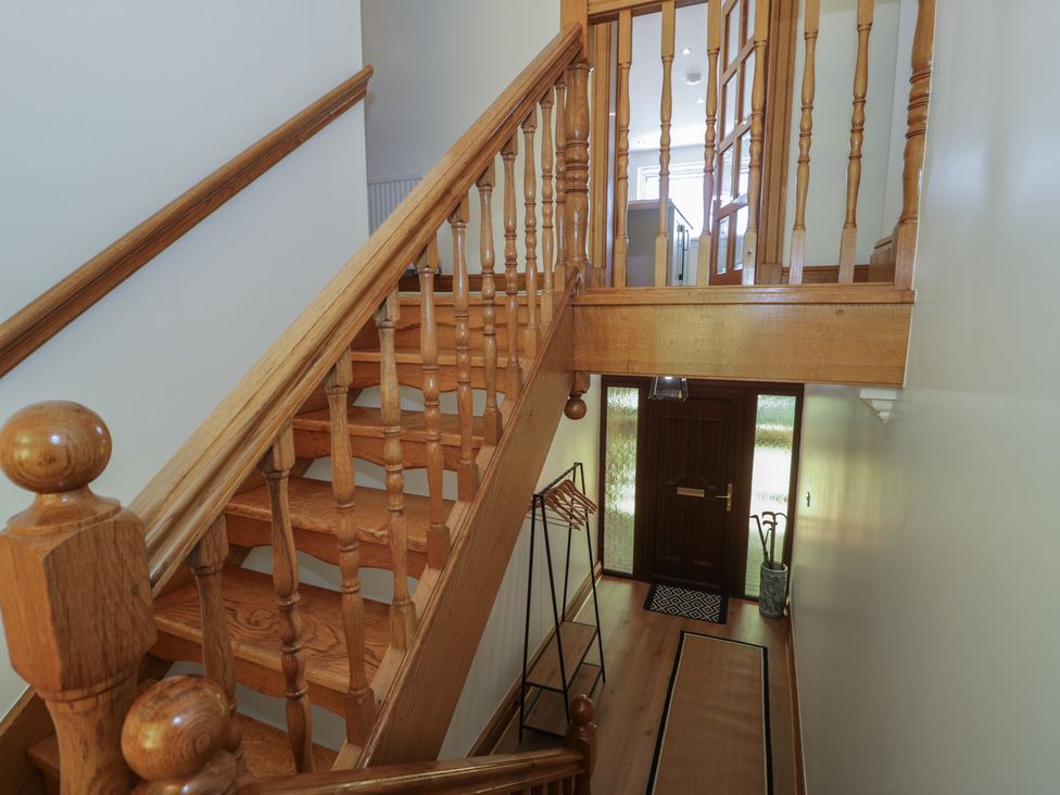 A staircase leading to an upper floor in The Boat Yard Apartment in Porthmadog