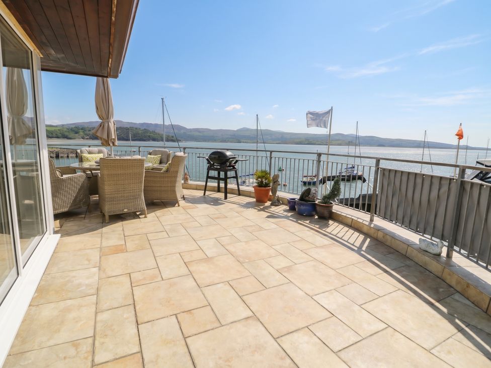 An outdoor area with seating and water views at The Boat Yard Apartment Porthmadog