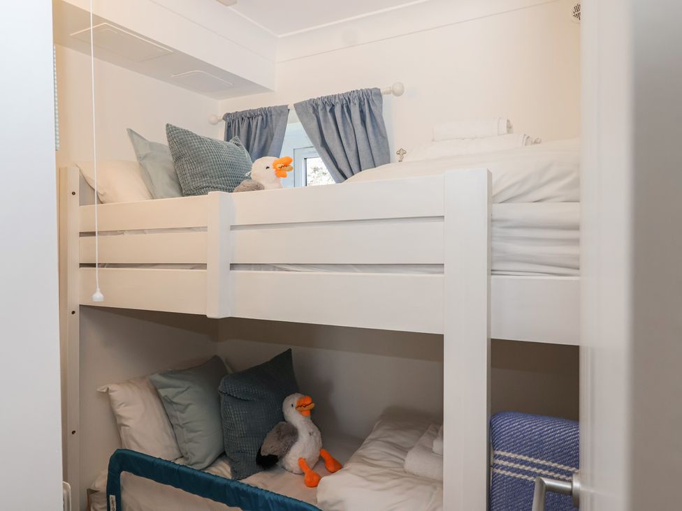 A children's bedroom with bunk beds and stuffed animals at 3 The Elms Salcombe