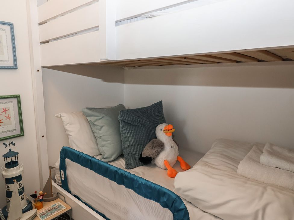 A bedroom with a loft bed and stuffed animal at 3 The Elms in Salcombe