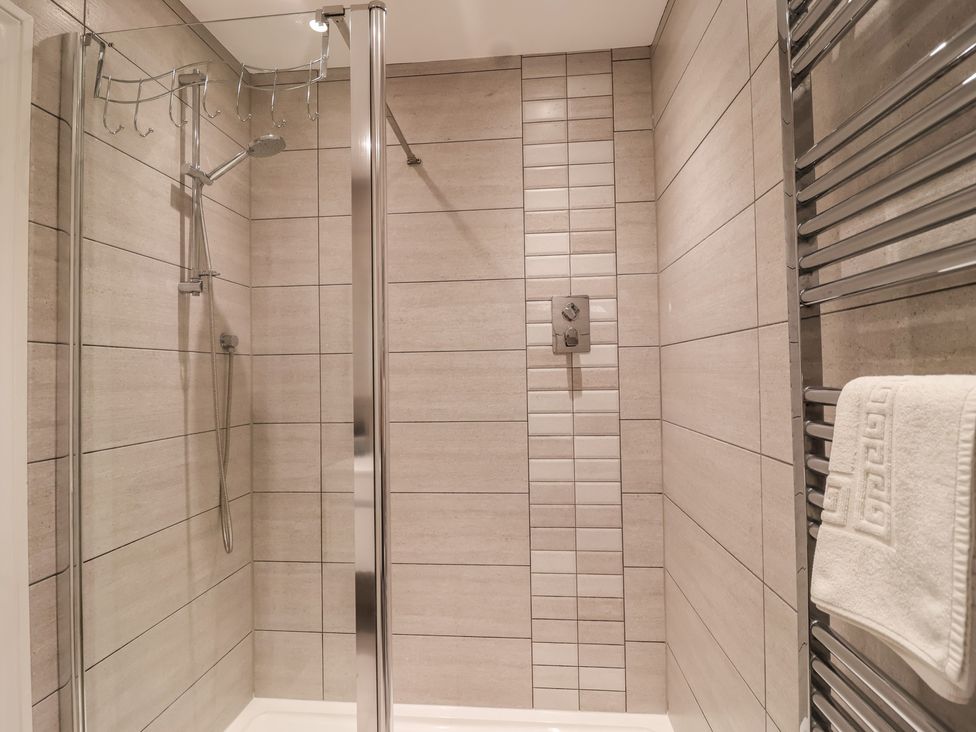 A shower area with towel rail and shower control at 3 The Elms in Salcombe