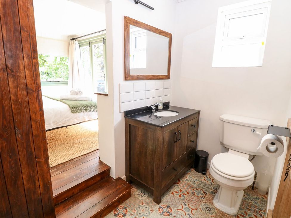 A bathroom with a sink and toilet at Vintner's Cottage in Reedham