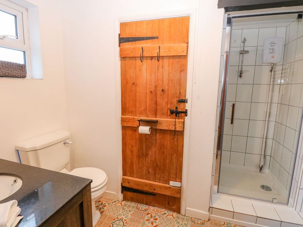 A bathroom with a toilet and a shower at Vintner's Cottage Reedham