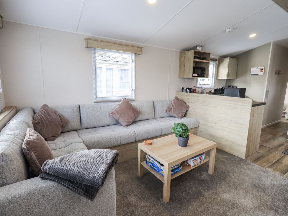 A living room with a sofa and coffee table at Hadrian's Rest in Wigton