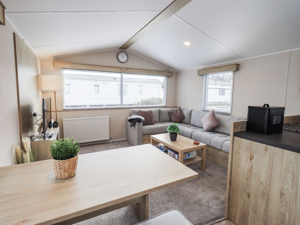 A living room with a sofa and coffee table at Hadrian's Rest in Wigton