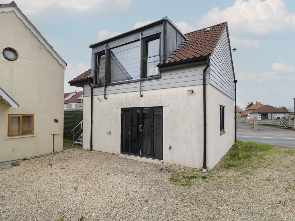 An outdoor view of a house with a balcony at The Nest in Meare near Glastonbury
