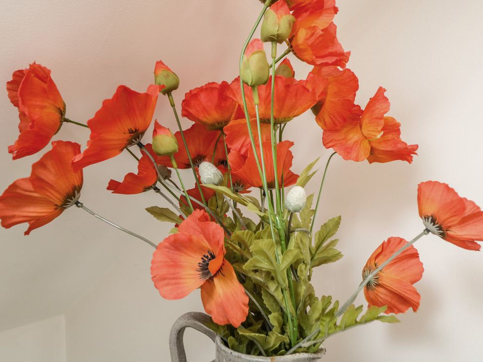 A bouquet of artificial poppies in a vase at The Nest in Meare near Glastonbury