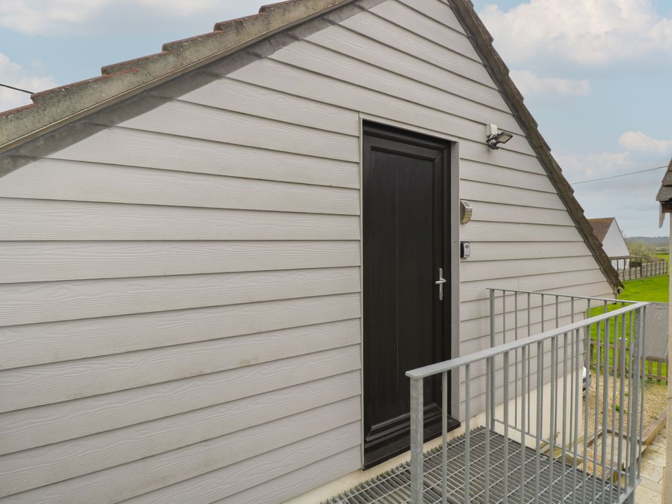 An entrance to a building with a door and steps at The Nest in Meare near Glastonbury