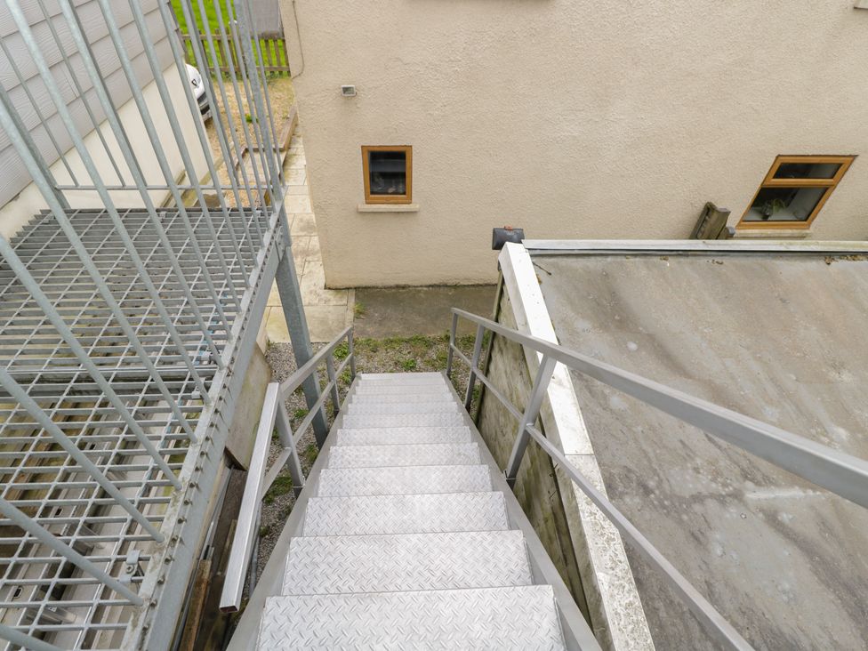A staircase leading down to an outdoor area at The Nest in Meare near Glastonbury
