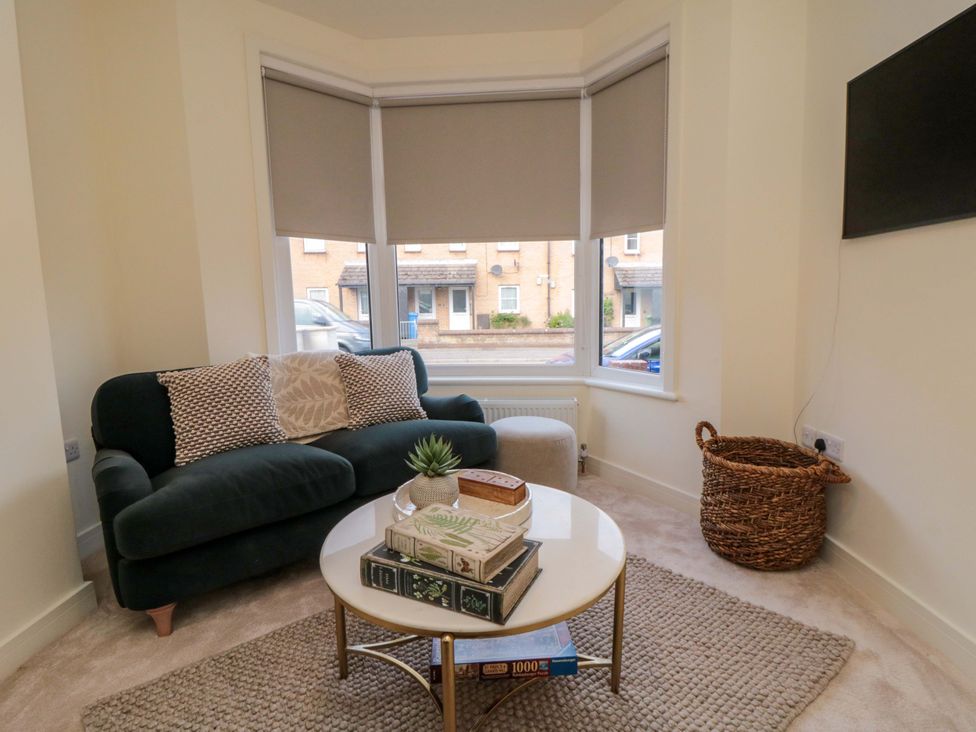 A living room with a sofa and a coffee table at No.9 Trafalgar St West Scarborough