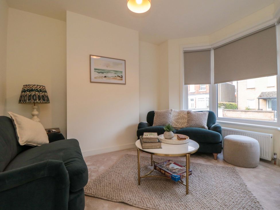 A living room with a sofa and a coffee table at No.9 Trafalgar St West in Scarborough