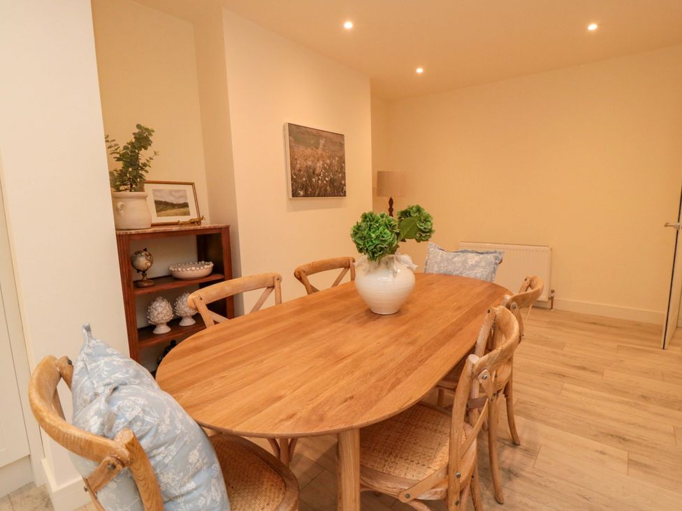 A dining room with a wooden table and chairs at No.9 Trafalgar St West Scarborough