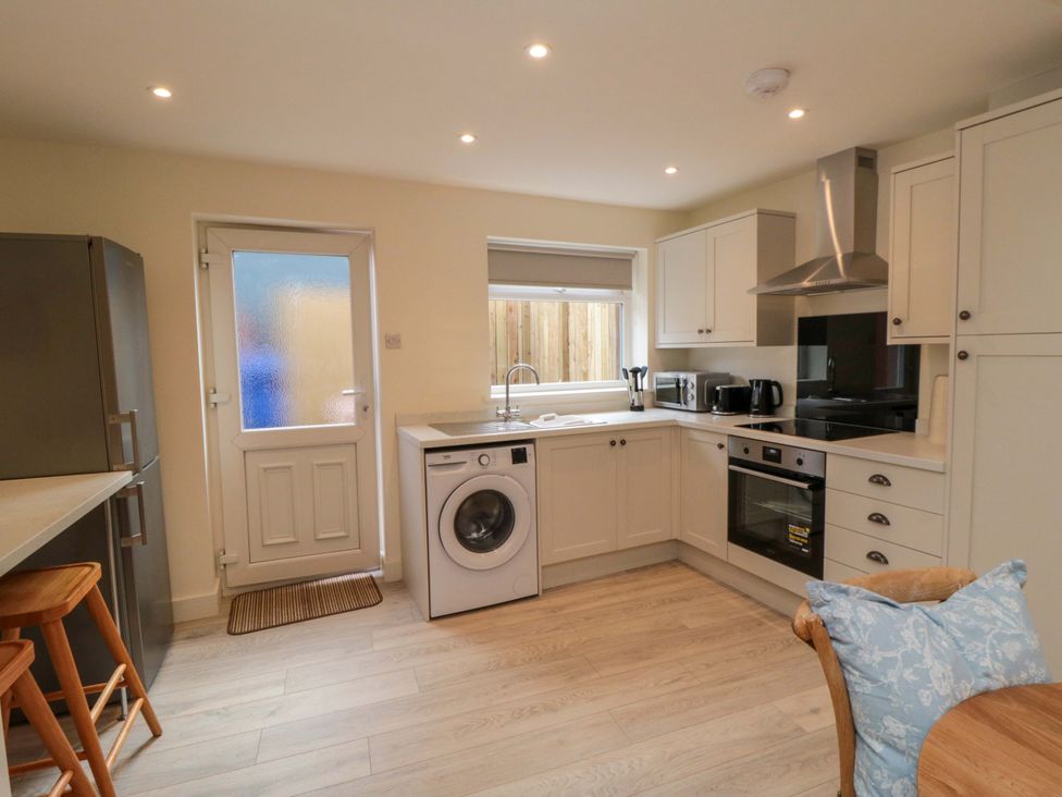 A kitchen with appliances and a dining table at No.9 Trafalgar St West Scarborough