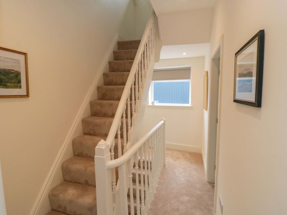 A hallway with stairs and a framed picture at No.9 Trafalgar St West Scarborough