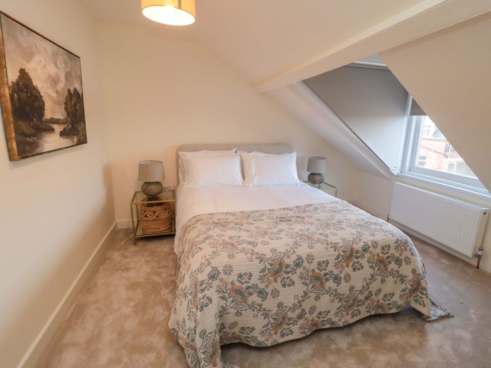 A bedroom with a bed and nightstand at No.9 Trafalgar St West Scarborough