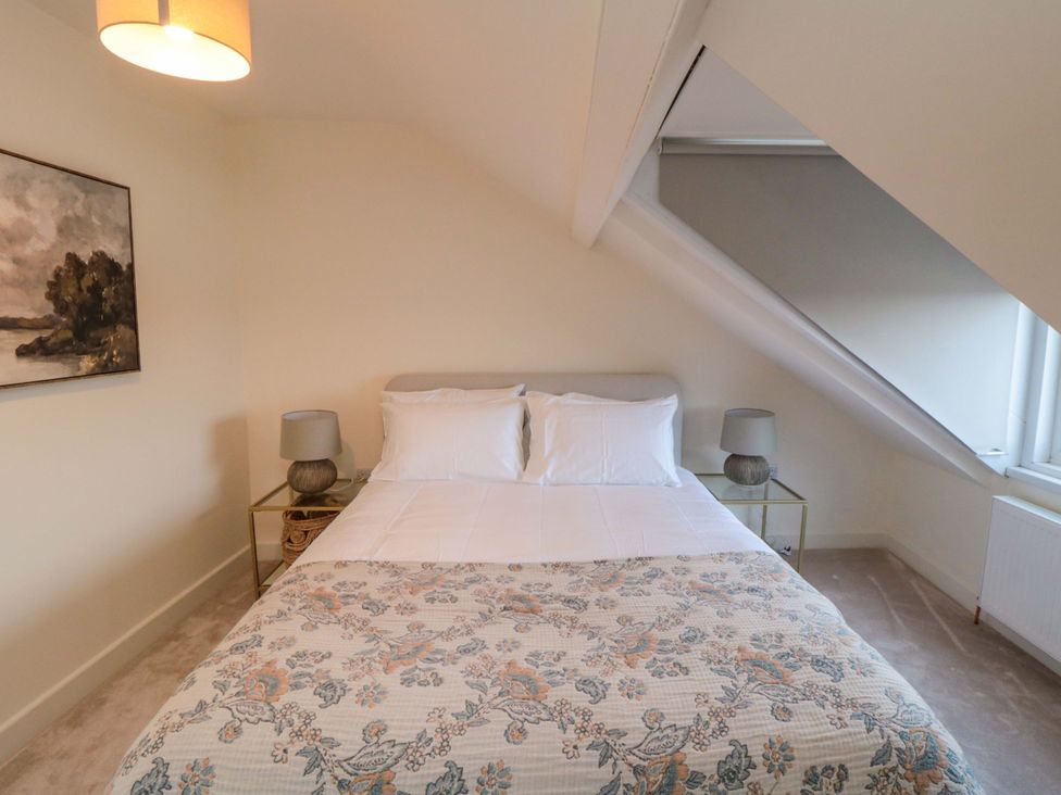 A bedroom with a bed and bedside tables at No.9 Trafalgar St West in Scarborough