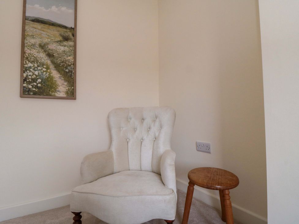 A corner seating area with an armchair and a small table at No.9 Trafalgar St West Scarborough