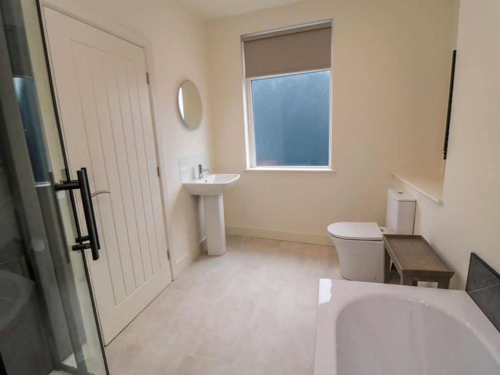 A bathroom with a bathtub, sink, and toilet at No.9 Trafalgar St West Scarborough