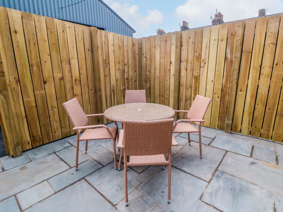 An outdoor patio with a table and chairs at No.9 Trafalgar St West Scarborough