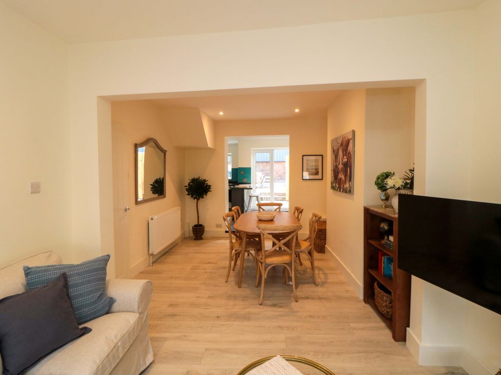 A living room with a dining area and television at No.8 Trafalgar St West Scarborough
